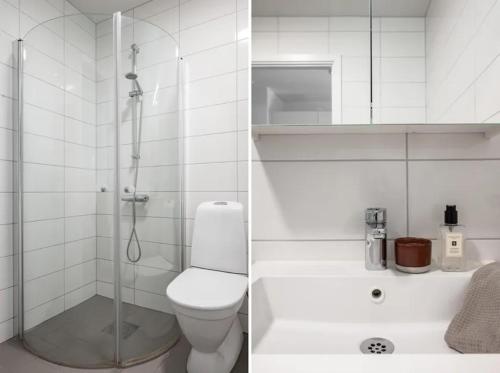 a white bathroom with a shower and a toilet at Appartment close to Hyllie in Klagshamn