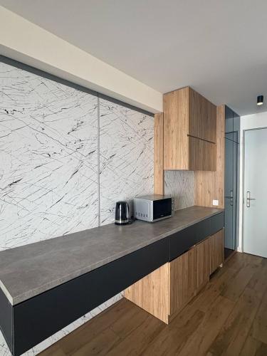 a kitchen with a counter with a microwave on it at Go-Gudauri The Atrium Residence in Gudauri