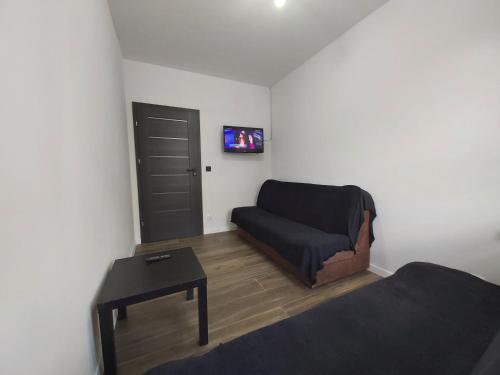 a living room with a couch and a table at 1140 Włościańska 5 - Tanie Pokoje w Apartamencie - samodzielne zameldowanie - self check in in Poznań