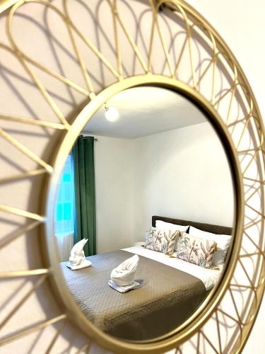 a bedroom with a bed and a mirror at S-HOUSE Avrig Apartament Spațios cu Terasă Privată lângă Sibiu in Avrig