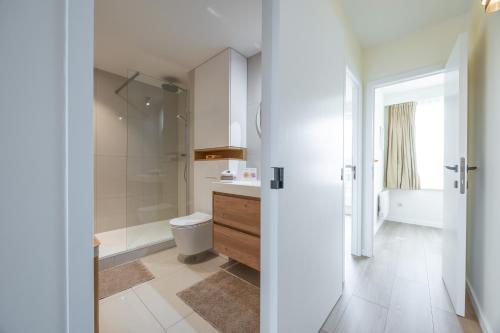 オーステンデにあるSunset Beach 7のトイレとシャワー付きの白いバスルーム