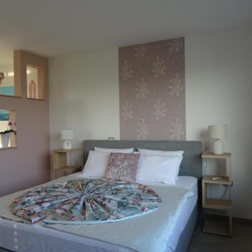 a bedroom with a bed with a blanket on it at Val&Sol Apartments in Sečovlje