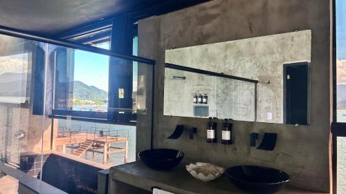 a bathroom with two sinks and a window at 1819 Marine Hotel in Ubatuba