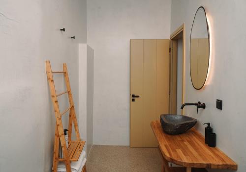 a bathroom with a black sink and a mirror at Cape Napos in Faros
