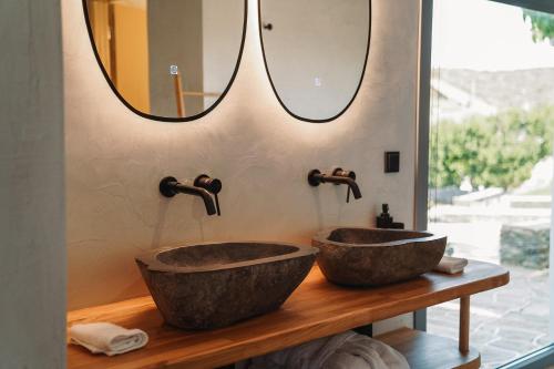 two sinks in a bathroom with a mirror at Cape Napos in Faros