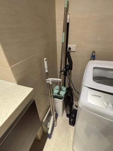 a room with a toilet and some ski poles at 300 Mbps WiFi , Netflix , Coffee machine , Tambuli in Lapu Lapu City