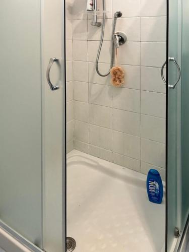 a shower with a glass door next to a tub at Casa Mirella in Aspra