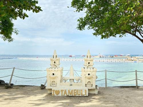 a sand castle on the beach next to the water at 300 Mbps WiFi , Netflix , Coffee machine , Tambuli in Lapu Lapu City