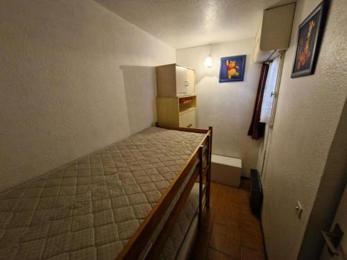 Cette petite chambre comprend un lit et une cuisine. dans l'établissement Résidence Terrasses De La Mediterranee 1 - 2 Pièces cabine 6 couchages PORT LEUCATE MAE-4734, à Port-Leucate