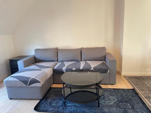 a living room with a couch and a table at Metro Apartment Linde Alle 14, 3Th 2720 Vanløse in Copenhagen