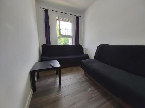 a living room with a couch and a table at 1140 Włościańska 5 - Tanie Pokoje w Apartamencie - samodzielne zameldowanie - self check in in Poznań
