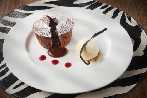 a piece of chocolate cake and ice cream on a plate at Pont du Chalon Hôtel and Restaurant in Margès
