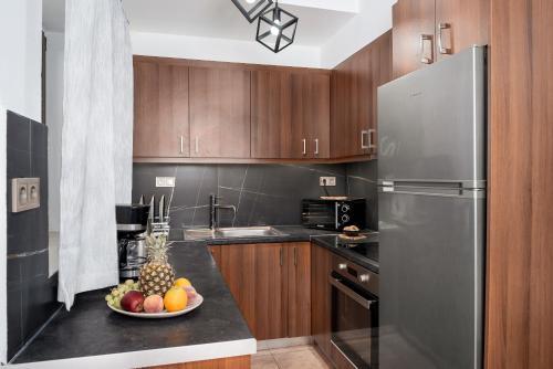 a kitchen with a bowl of fruit on a counter at Villa Foteini Gerakari Mountain Resort in Yerakárion