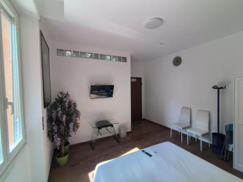 a bedroom with a bed and a table and chairs at Camera Appartamento Terminal Traghetti in Genova