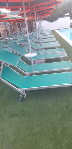a row of empty bleachers next to a swimming pool at Residence Il Grande Orso in Ateleta