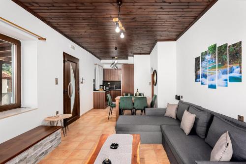 a living room with a couch and a table at Villa Foteini Gerakari Mountain Resort in Yerakárion