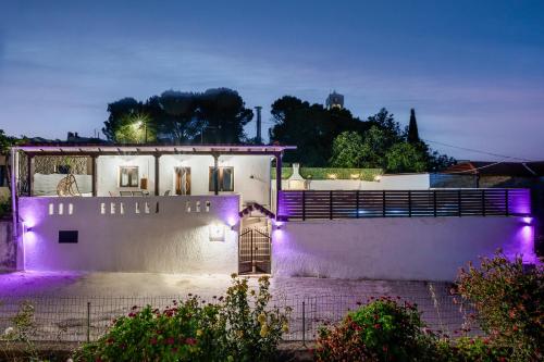 a building with purple lights on it at night at Villa Foteini Gerakari Mountain Resort in Yerakárion