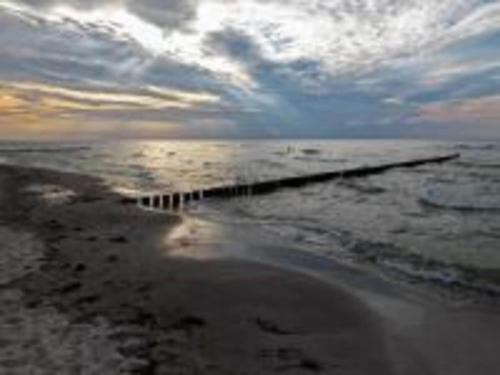 a view of the ocean with a pier in the water at Apartment in Warin in der N he des Glammsees in Warin