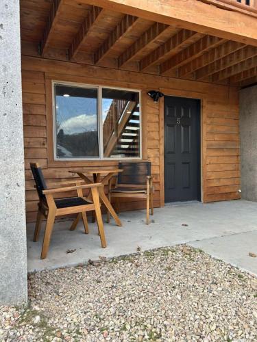 a wooden house with a bench and a window at Cowboy Hot Tub and Alleged Alien Sightings in Alton