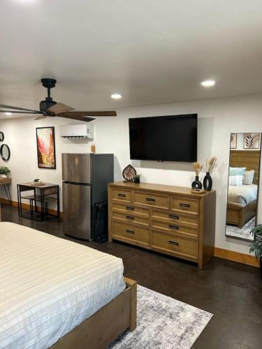 a bedroom with a bed and a flat screen tv at Cowboy Hot Tub and Alleged Alien Sightings in Alton