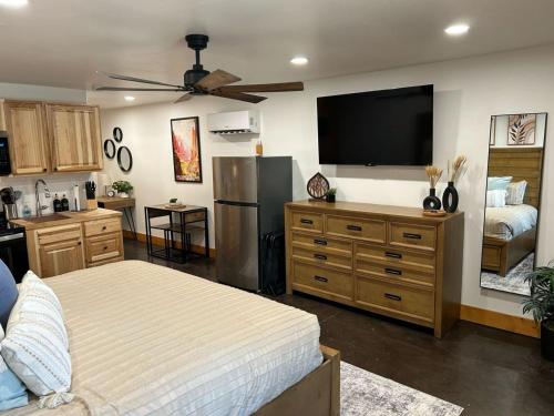 a living room with a bed and a flat screen tv at Cowboy Hot Tub and Alleged Alien Sightings in Alton
