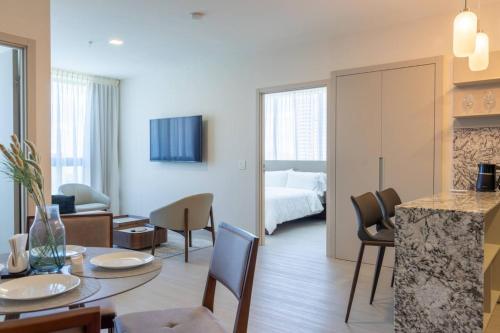 a living room with a kitchen and a bedroom at Deluxe Condo Suite 2BR With City View in Panama City