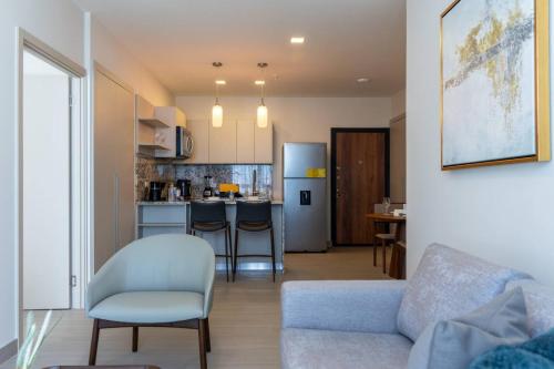 a living room with a couch and a kitchen at Deluxe Condo Suite 2BR With City View in Panama City