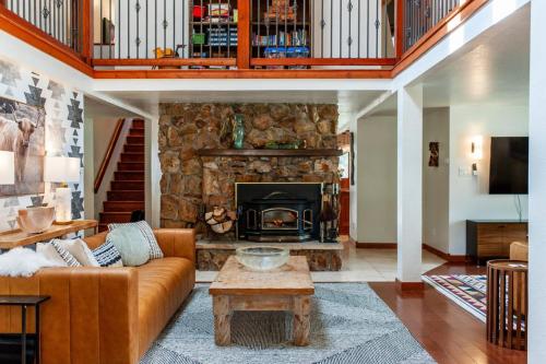 a living room with a couch and a fireplace at Creek-Hot Tub-View-Pets-10min DT in Durango