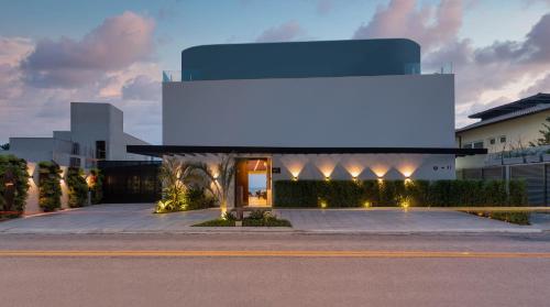 a building with a blue sign on the side of it at Duke Beach Hotel Maresias in Maresias