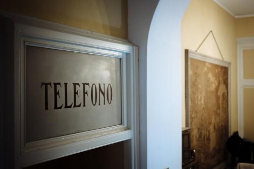 a window in a room with the words telephone at Hotel Belle Epoque in Sanremo