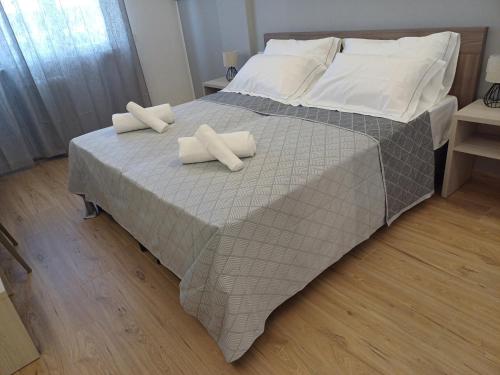 a large bed with two white pillows on it at Luxury Rooms Bari in Bari