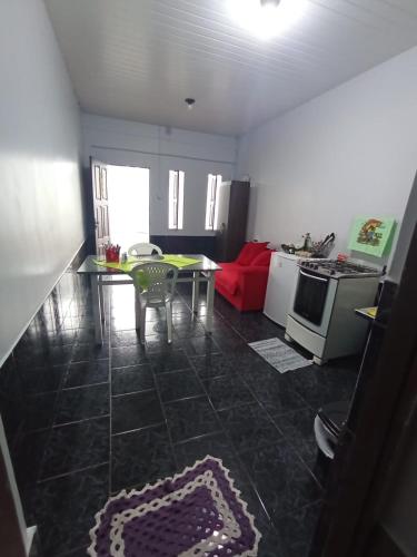 a living room with a table and a kitchen at Apartmento G in Macapá