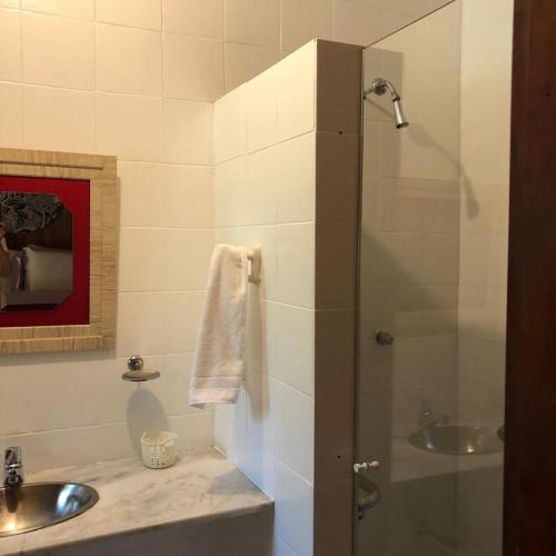 a bathroom with a sink and a glass shower at VILLA MIA DUO in Itaipava