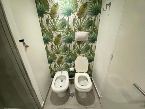 a bathroom with a toilet and a plant wall at Apartment in central Palermo, BsAs, full amenities in Buenos Aires