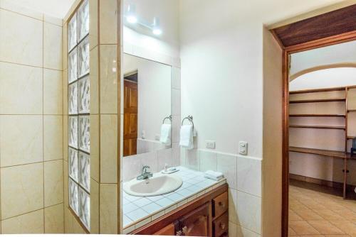 a bathroom with a sink and a mirror at Grand Plaza in San Juan del Sur