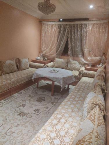 a living room with a couch and a table at Mogadorista pour les familles in Essaouira