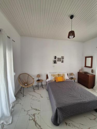 a bedroom with a bed and a white wall at Casa di Kontessa in Acharavi
