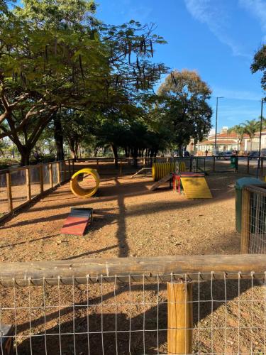 a park with a playground with slides and play equipment at Quarto Econômico no Centro para 2 Pessoas in Sete Lagoas