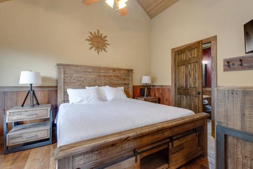 a bedroom with a large bed with a wooden headboard at Lost Horizon by Venture Smoky Mountains in Sevierville