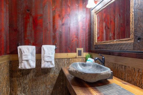 a bathroom with a large stone sink and towels at Lost Horizon by Venture Smoky Mountains in Sevierville