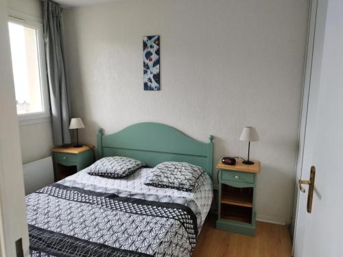 a small bedroom with a bed and two night stands at Résidence Royal Peyragudes Mp - T2/6pers -ROYAL 44A- Peyresourde MAE-3601 in Germ