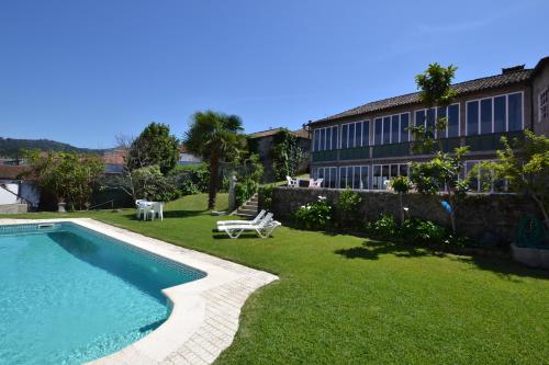 a resort with a swimming pool and a building at Casa Nobre do Correio-Mor in Ponte da Barca