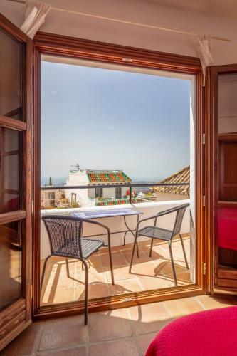 a view of a balcony with a table and chairs at La Casa de la Iglesia in Mijas