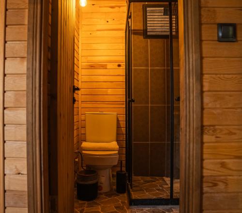 a bathroom with a toilet in a room at Reflections Camp in Faralya