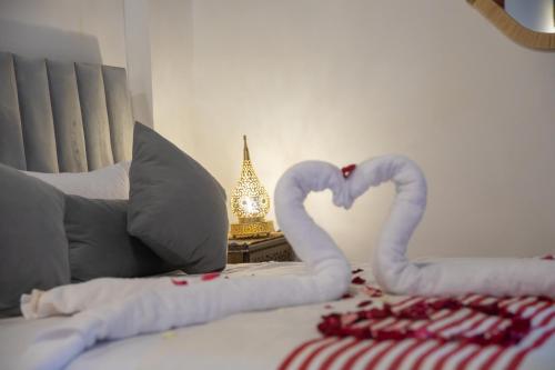 a bed with two swans made to look like hearts at Riad Soufiya Palace - Silent Luxury in Fès