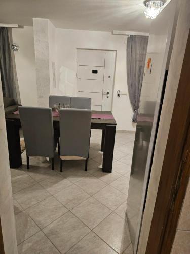 a dining room with a table and chairs at Apartmani Sabotic in Sutomore
