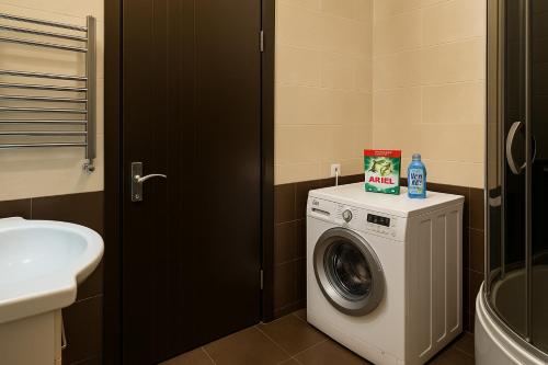 a bathroom with a washing machine and a sink at GOAL ApartmentS 2 in Tbilisi City