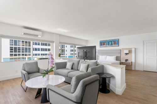a living room with a couch and a bed at Ocean Sky Hotel & Resort in Fort Lauderdale