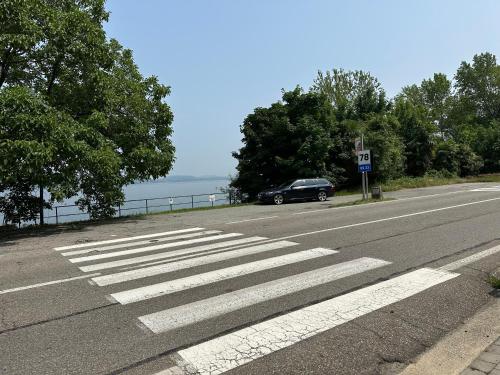 a car parked on the side of a road with a crosswalk at Stresa vista lago con CINEMA e SPIAGGIA in Brisino