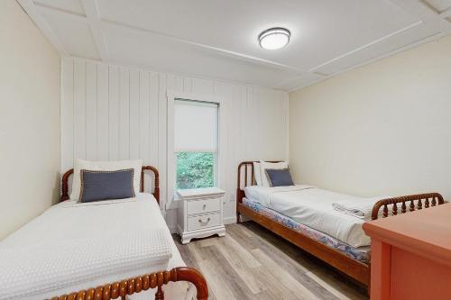 a bedroom with two beds and a window at Bliss on the Bluff in Crosby
